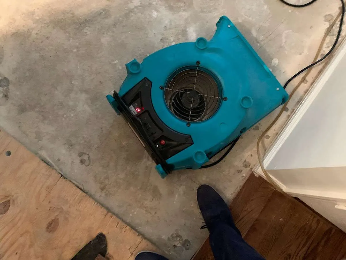 Air mover drying subfloor during Leak Detection & Repair in Ashwaubenon